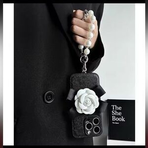 CHANEL Black Phone Case with White Floral Accent